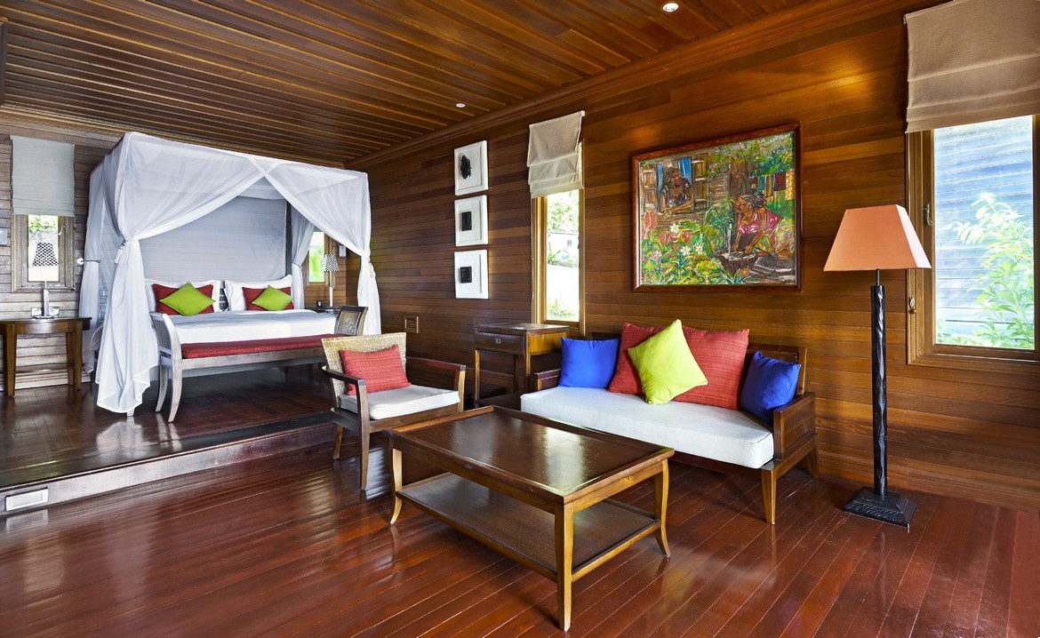 Spacious wooden suite at Hilton Seychelles Northolme Resort with canopy bed