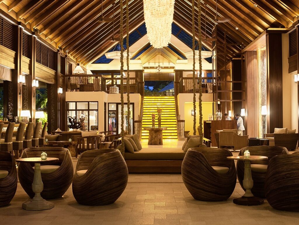 Story of a luxurious lobby with warm lighting and modern wooden furniture in an elegant resort setting