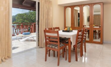 Suite dining area at Coral Strand Hotel Seychelles with balcony access