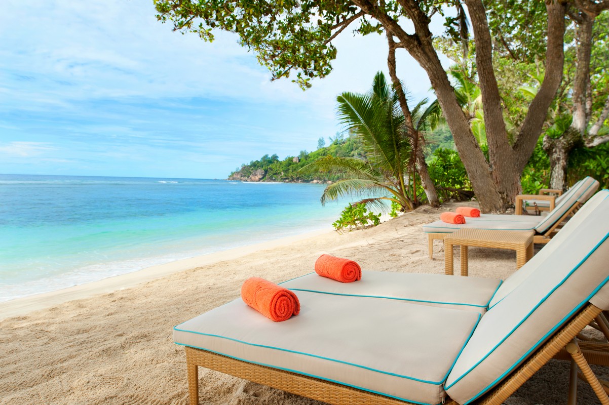 Sun loungers on Baie Lazare Beach at Kempinski Seychelles Resort