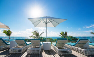 Sun loungers on deck overlooking the ocean at Radisson Blu Poste Lafayette