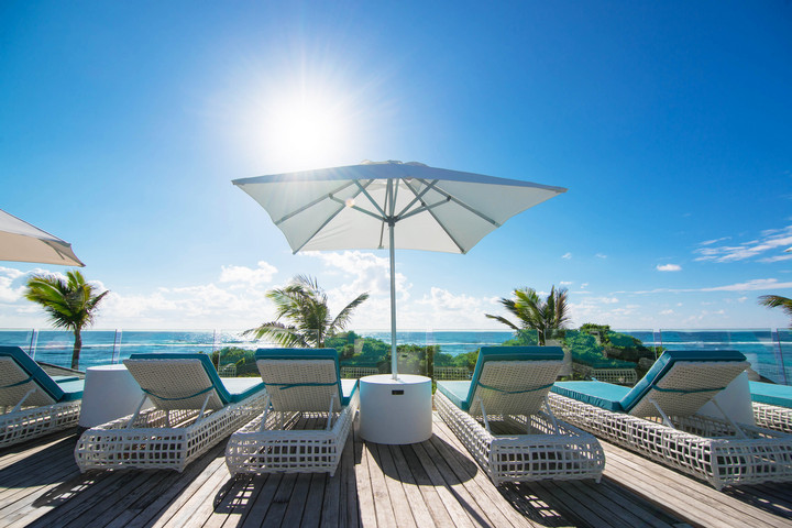 Sun loungers on deck overlooking the ocean at Radisson Blu Poste Lafayette