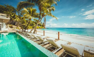 Sun loungers on the deck at Carana Beach Hotel beachfront