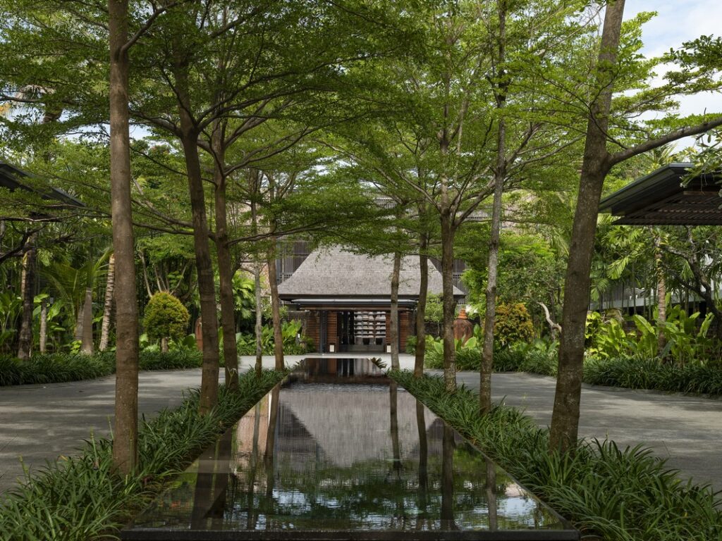 The Anvaya Bali with a reflective pond and lush trees