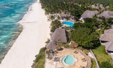 Aerial view of Karafuu Beach Resort beachfront villas and blue ocean