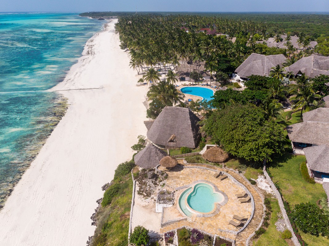 Aerial view of Karafuu Beach Resort beachfront villas and blue ocean