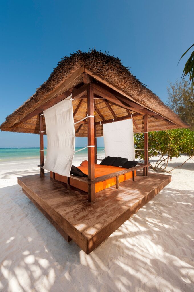 Beachfront cabana at Melia Zanzibar with a shaded daybed on the sand