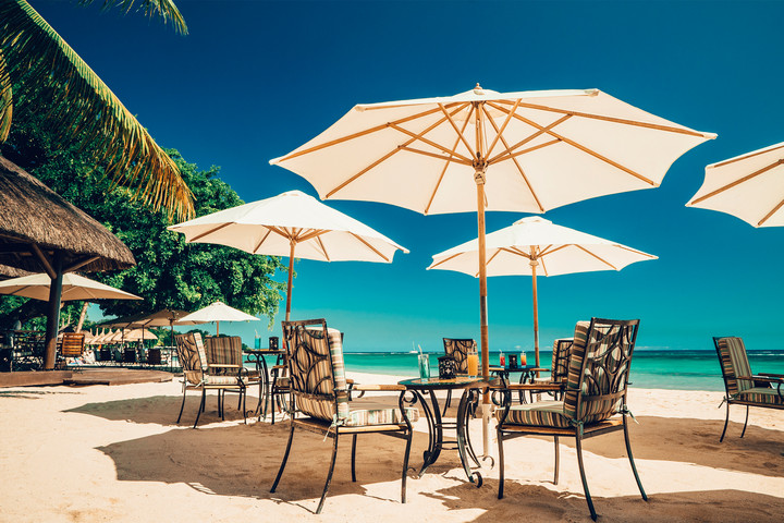Beachfront dining at Maritim Resort with shaded tables