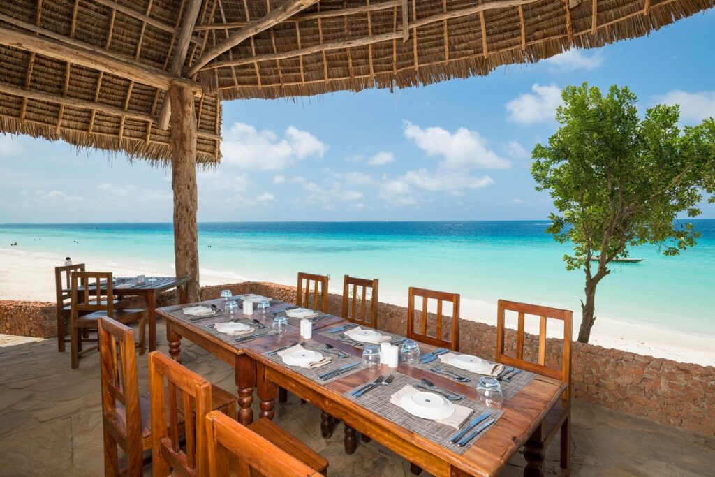 Beachfront dining at Sandies Baobab Beach Resort with turquoise water views