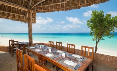Beachfront dining at Sandies Baobab Beach Resort with turquoise water views