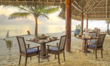 Bluebay Beach Resort beachfront dining with ocean views and sunset ambiance