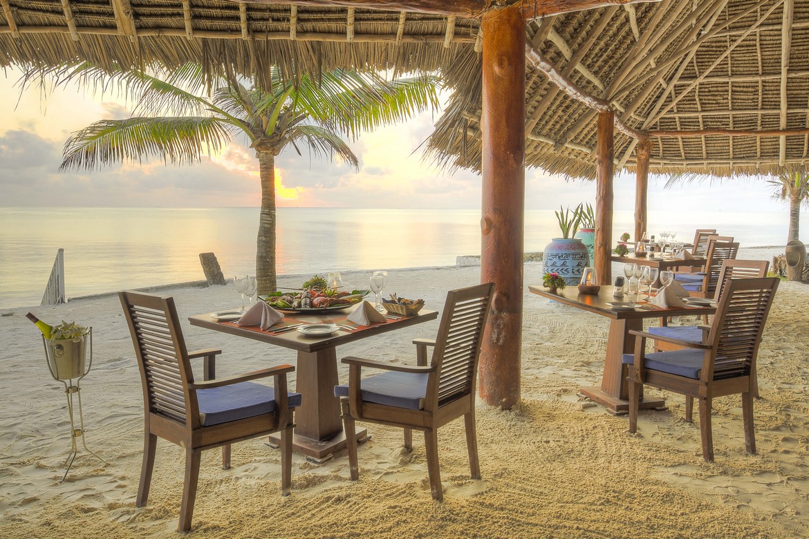 Bluebay Beach Resort beachfront dining with ocean views and sunset ambiance