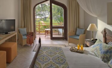 Bluebay Beach Resort cozy room with a private terrace overlooking the gardens