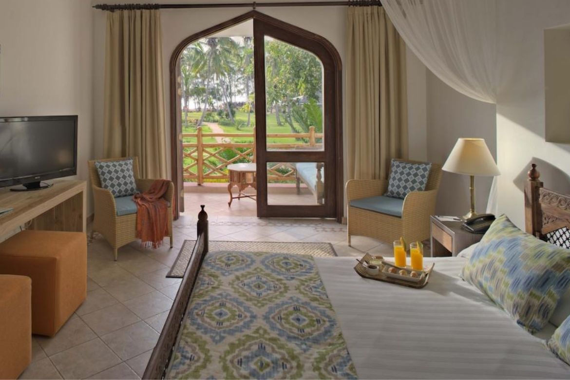 Bluebay Beach Resort cozy room with a private terrace overlooking the gardens