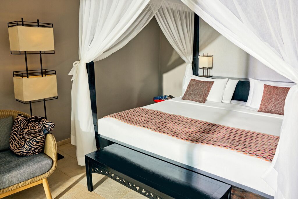 Cozy bedroom at Tui Blue Bahari featuring a canopy bed with white curtains