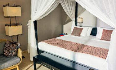 Cozy bedroom at Tui Blue Bahari featuring a canopy bed with white curtains