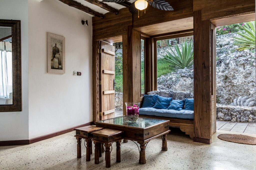 Cozy lounge with wooden decor at Karafuu Beach Resort overlooking nature