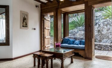 Cozy lounge with wooden decor at Karafuu Beach Resort overlooking nature