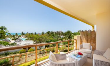 Cozy seating area on a balcony overlooking the lush landscape of Gold Zanzibar