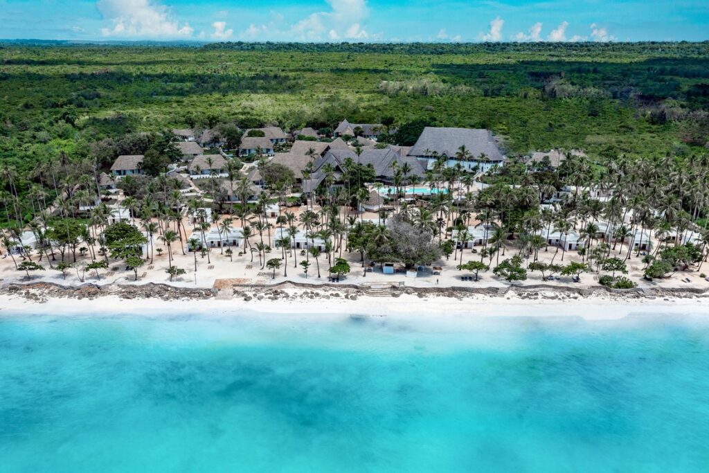 Diamonds Mapenzi Beach Resort aerial view of beachfront villas and palm trees