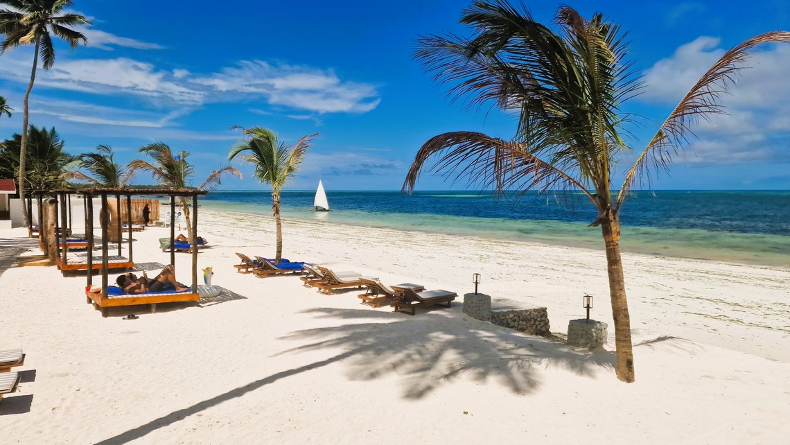 Dream of Zanzibar beachfront with sunbeds and swaying palm trees