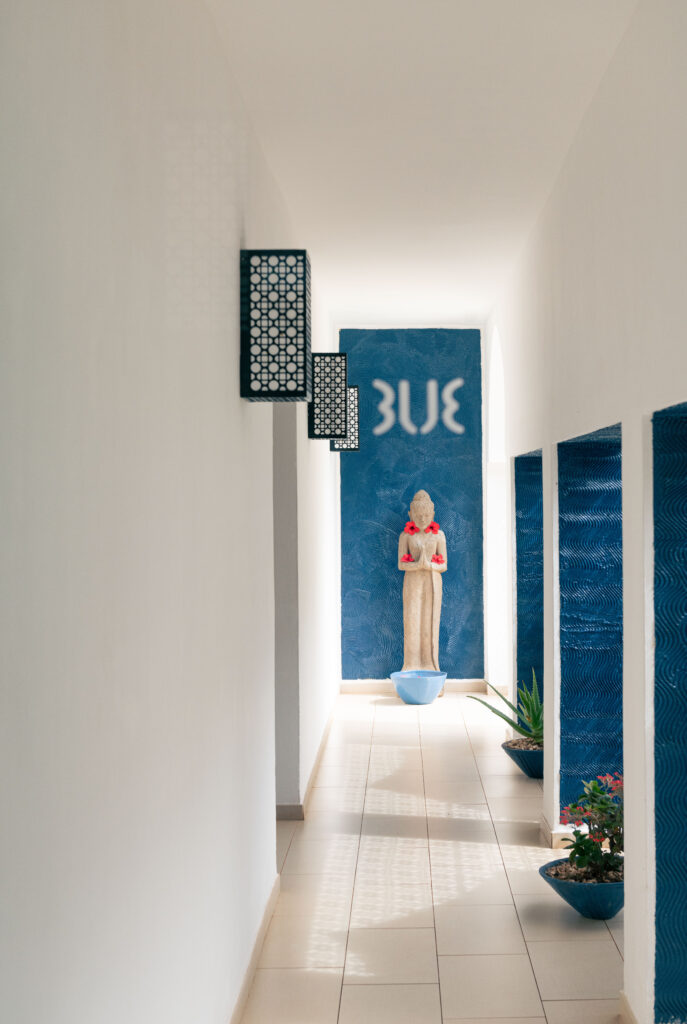 Hallway with a Buddha statue and blue accents at Tui Blue Bahari