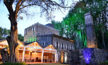 Historic stone building at Maritim Resort with lush surroundings