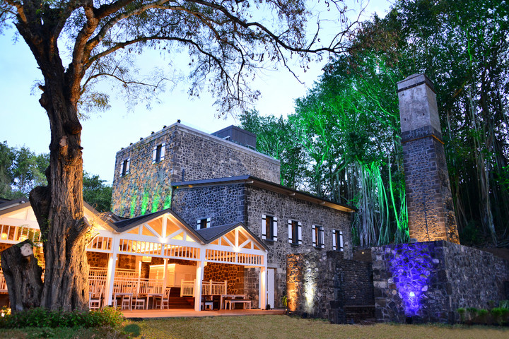 Historic stone building at Maritim Resort with lush surroundings