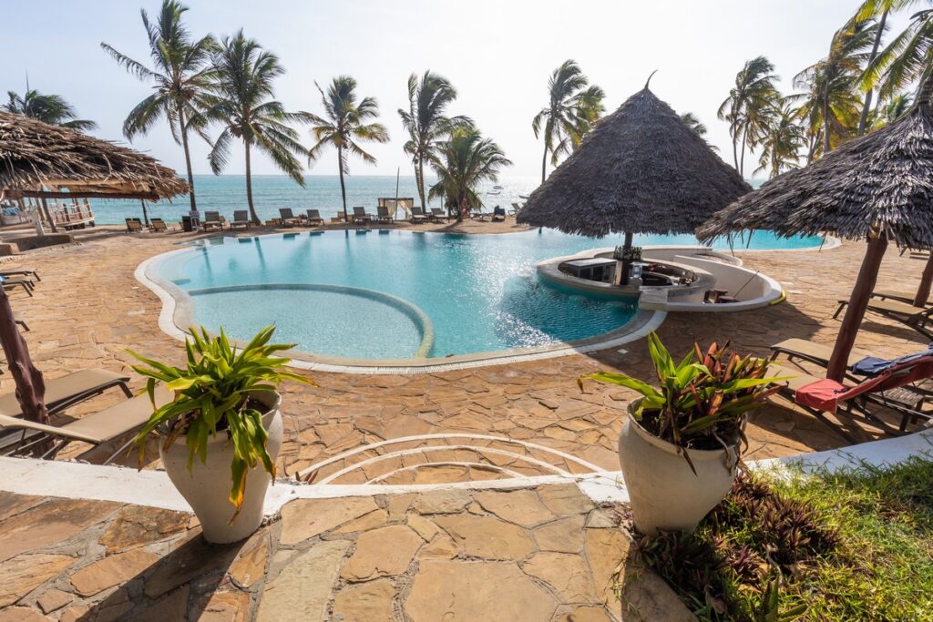 Infinity pool at Karafuu Beach Resort with ocean views and sun loungers