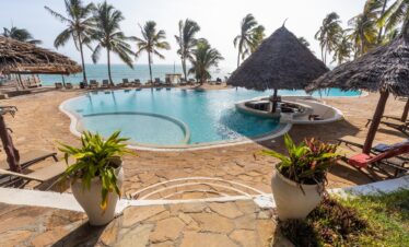 Infinity pool at Karafuu Beach Resort with ocean views and sun loungers
