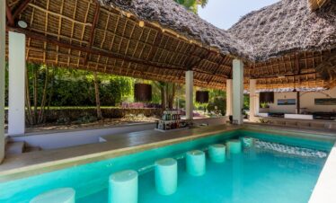 Karafuu Beach Resort swim-up bar with thatched roof and tropical setting