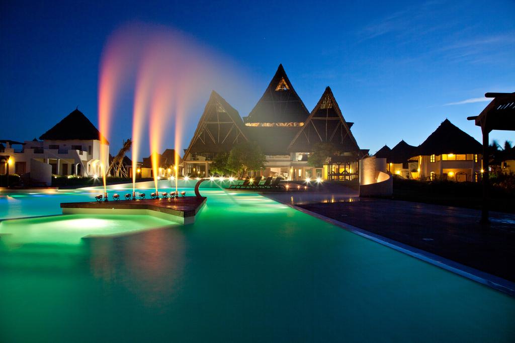 Night view of the pool and main building at Essque Zalu Zanzibar
