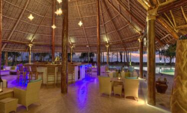 Open air bar at Bluebay Beach Resort with tropical cocktails and ocean views