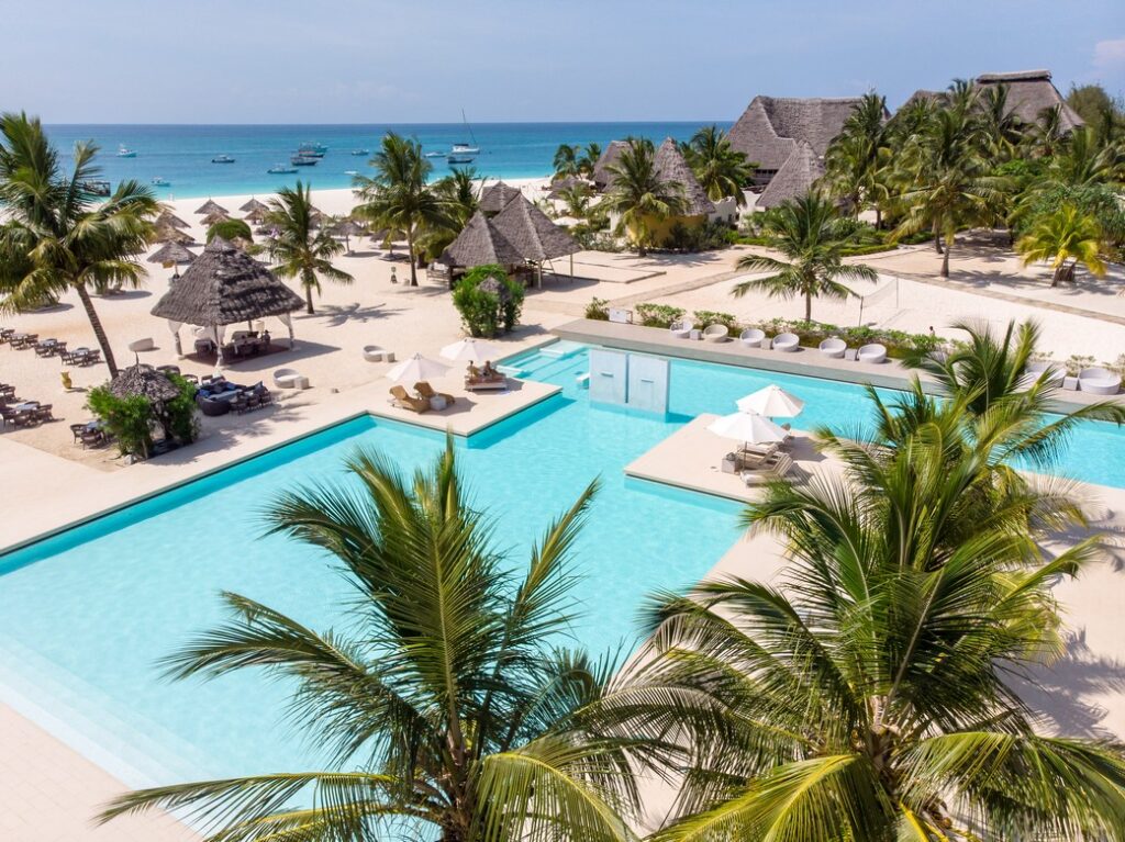 Overlooking the pristine pools and palm trees at Gold Zanzibar resort by the beach