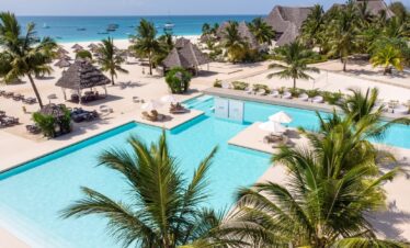 Overlooking the pristine pools and palm trees at Gold Zanzibar resort by the beach