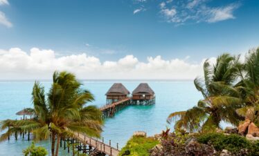 Overwater bungalows at Melia Zanzibar surrounded by blue waters