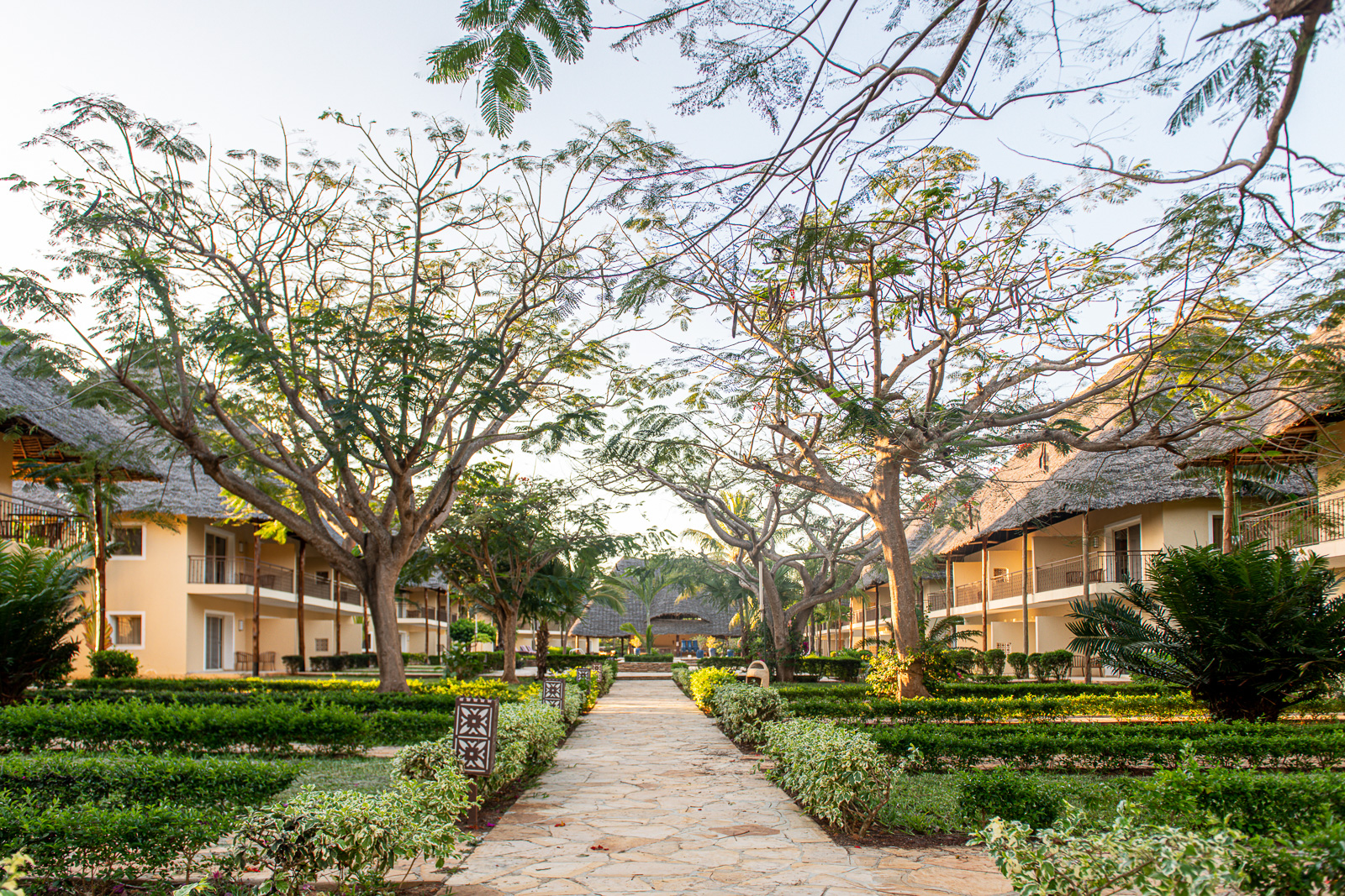 Pathway through well manicured gardens and trees leading to accommodations at Tui Blue Bahari
