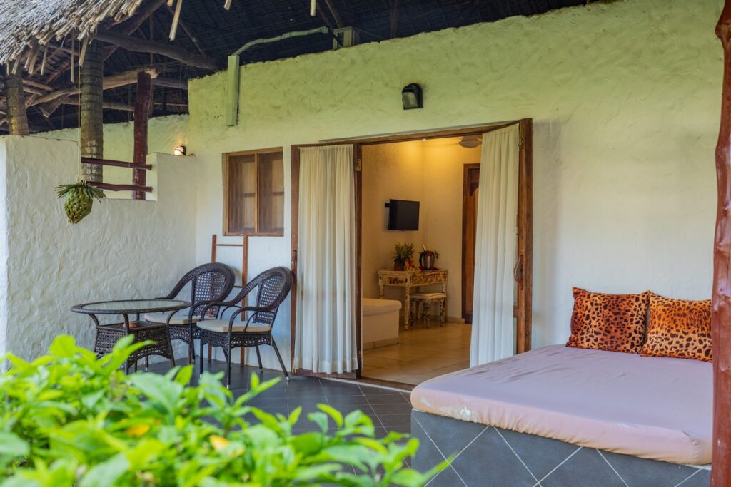 Private patio with seating at Karafuu Beach Resort overlooking lush gardens