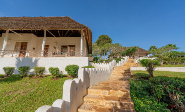 Private villa entrance at Diamonds Mapenzi Beach Resort with lush gardens
