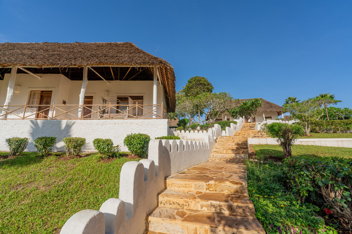 Private villa entrance at Diamonds Mapenzi Beach Resort with lush gardens