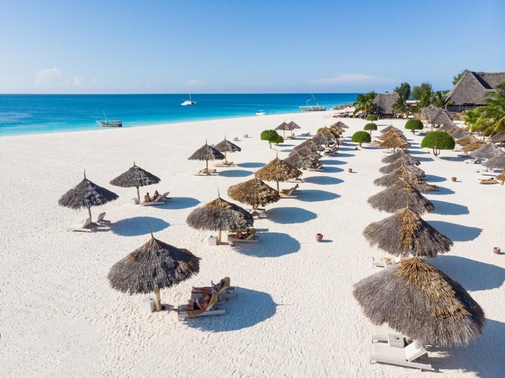 Rows of thatched umbrellas on the white sandy beach of Gold Zanzibar
