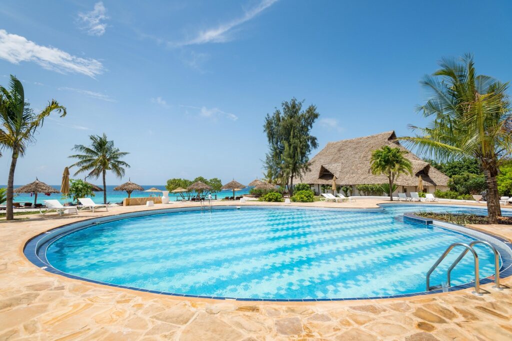 Sandies Baobab Beach Resort pool with ocean views and tropical palm trees