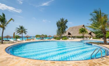 Sandies Baobab Beach Resort pool with ocean views and tropical palm trees