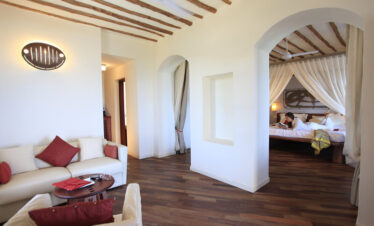 Spacious living area in a suite at Essque Zalu Zanzibar with a cozy setup