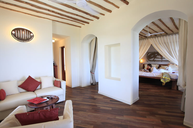 Spacious living area in a suite at Essque Zalu Zanzibar with a cozy setup