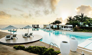 Sunset reflecting on the infinity pool at Essque Zalu Zanzibar