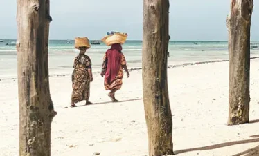 Couple walking on the beach at Matemwe Attitude Zanzibar
